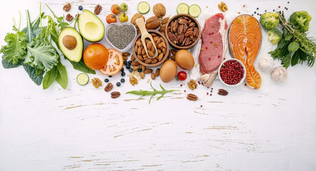Ketogenic low carbs diet concept. Ingredients for healthy foods selection on white wooden background. Balanced healthy ingredients of unsaturated fats for the heart and blood vessels.